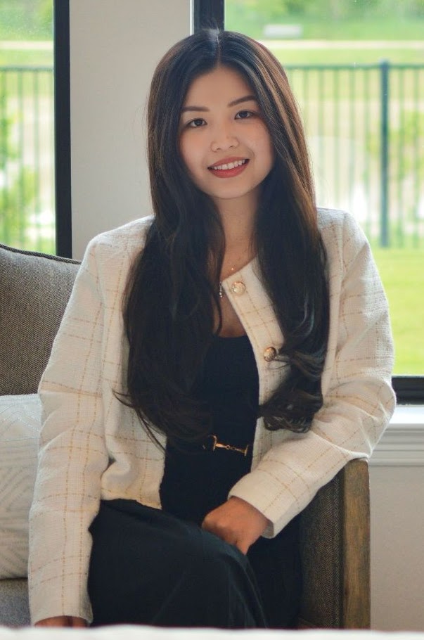 Trinh Hoang seated by a bright window